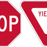 red and white stop yield signs