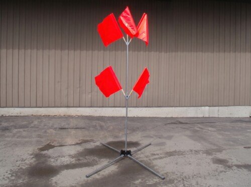 Galvanized steel flag tree stand with T-pin leg release system deployed in a work zone.