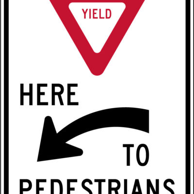 yield here to pedestrians left sign