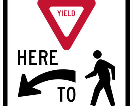 yield here to pedestrians left sign