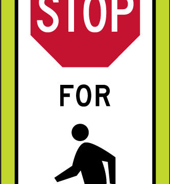 state law stop pedestrians crosswalk yellow panel sign