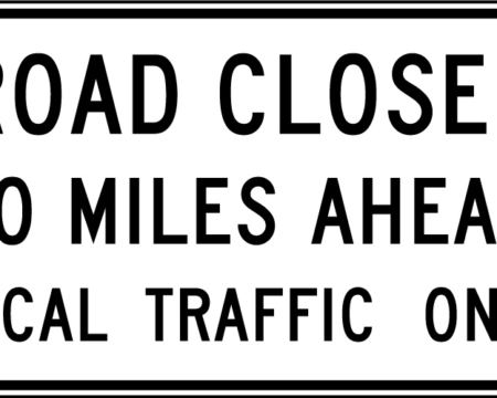 road closed miles ahead local traffic ahead white sign