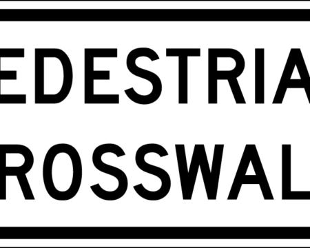 white pedestrian crosswalk sign