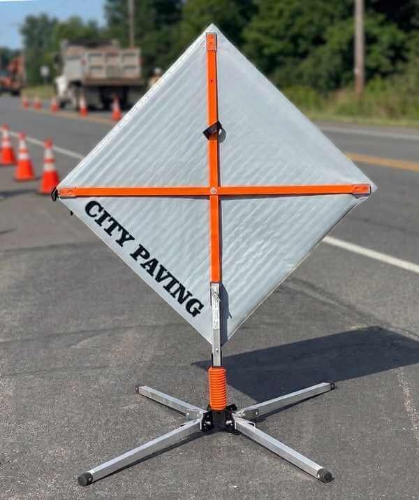 Back of a roll-up traffic sign showing custom branding and messaging
